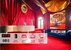 a room with red curtains and a table and a sign at 10 Très Grande Chambre insolite double volume XL, proximité gare de tourcoing in Tourcoing