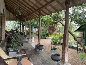 a pavilion with chairs and plants in a garden at Lali Villa in Galle