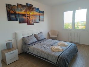 a bedroom with a bed with two towels on it at Belvédère du bonheur in Samatan +27 photos