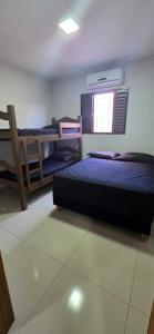 a bedroom with three beds and a window at Por ti Maria in Olímpia +21 photos