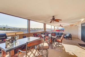a living room with a table and chairs at Balcony and Grill Beachfront Lake Havasu City Condo in Lake Havasu City