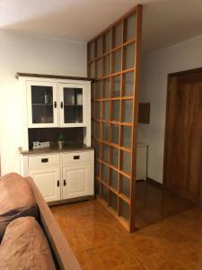 a living room with a large white cabinet with glass doors at The Calm Residence - Gondomar 