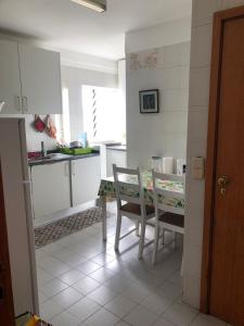 a kitchen with a table and a table and chairs at The Calm Residence - Gondomar 