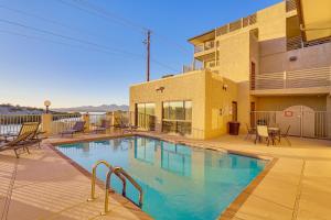 a swimming pool in front of a building at Balcony and Grill Beachfront Lake Havasu City Condo in Lake Havasu City