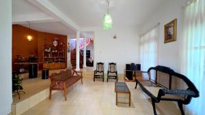 a living room with a couch and chairs in it at Ceylon Bliss Retreat- Kandy Wellness Hotel in Kandy
