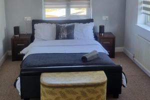 a bedroom with a large bed with a book on it at Doncaster Dream House Retreat- Sleeps 9 in Doncaster