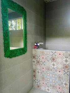 a bathroom with a green mirror on the wall at House & Spa Tropical Home with Private Jacuzzi Koh Phangan in Ko Phangan +17 photos