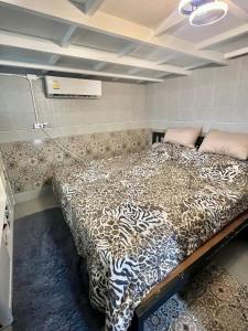 a bedroom with a large bed in a room at House&Spa in Koh Phangan