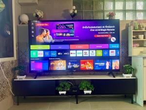 a large screen television on a stand in a room at House & Spa Tropical Home with Private Jacuzzi Koh Phangan in Ko Phangan