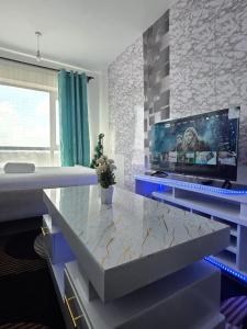 a room with a table with a laptop on it at Be Happy Homes Tsavo Fedha 513 in Nairobi