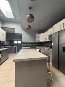 a large kitchen with white cabinets and a granite counter top at Infinity Apartments in Lusaka