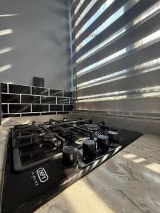 a stove top with four burners in a kitchen at Infinity Apartments in Lusaka +4 photos