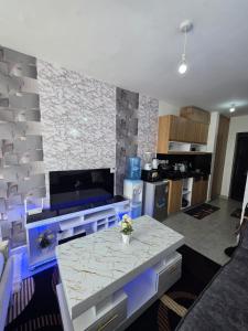a kitchen with a table and a counter top at Be Happy Homes Tsavo Fedha 513 in Nairobi