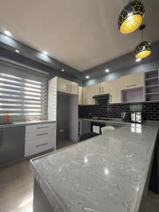 a large kitchen with a large marble counter top at Infinity Apartments in Lusaka