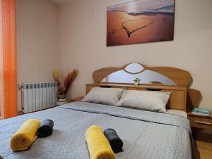 a bedroom with a bed with two towels on it at Mladost the City of Fountains Vitosha View in Sofia