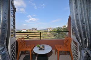 a balcony with a table and chairs and a view at ll EMPYREAN STAY ll VALENTINA VILLA ll 2BHK ll AC ll PRIVATE POOL ll in Lonavala