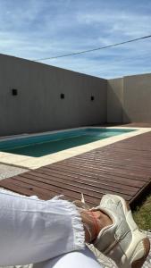a pair of shoes sitting on a deck next to a swimming pool at La curva in Ramallo