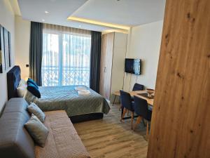 a hotel room with a bed and a couch and a table at Harmony, Residence Hill A85 in Kopaonik +28 photos