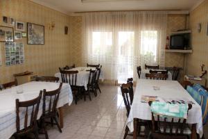 a dining room with tables and chairs and a television at Apartments and rooms with parking space Palit, Rab - 3195 in Rab