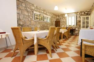 a dining room with a table and chairs at Apartments with parking space Trpanj, Peljesac - 10046 in Trpanj +26 photos