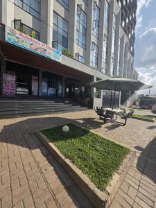 a building with a table and an umbrella in front of it at Be Happy Homes Tsavo Fedha 513 in Nairobi
