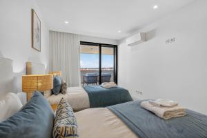 En eller flere senge i et værelse på Vista Lagos Luxury Apartment + 23 billeder