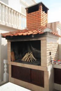 a brick oven with a pile of wood in it at Apartments with a parking space Rukavac, Vis - 8838 in Vis