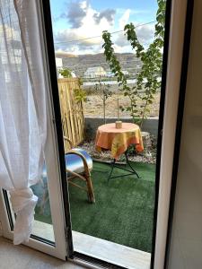 a sliding glass door with a table and a chair at Athos studio in Análipsis