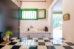 eine Küche mit schwarz-weiß kariertem Boden in der Unterkunft Carmel Emerald in Haifa + 13 Fotos