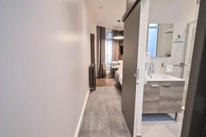 a bathroom with a sink and a mirror at Les cles du 27 Paris in Paris +160 photos