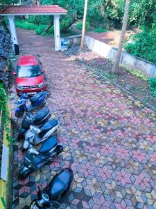 a row of motorcycles parked next to a car at Private Spacious family 1 Bhk Apartment in Arambol in Jāmb