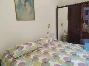 a bed with a blanket on it in a room at AllogGio' in Calice Ligure +14 photos