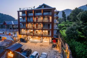 a large building with cars parked in front of it at Alt Life Luxe - Uppper Bhagsu Mcleodganj in McLeod Ganj