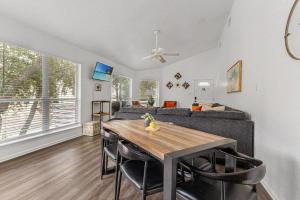 a living room with a table and a couch at Spacious Cabin Rental Overlooking the Guadalupe River near Austin, Texas in Fourth Crossing