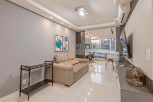 a living room with a couch and a table at 413 Trend Residence High Standard in Porto Alegre