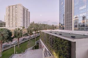 a view of a city with tall buildings and palm trees at 413 Trend Residence High Standard in Porto Alegre