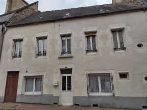 un antiguo edificio de ladrillo con ventanas y una puerta en Gite Iza, en Lormes