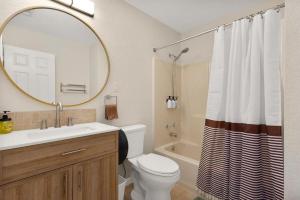 a bathroom with a sink and a toilet and a mirror at Spacious Cabin Rental Overlooking the Guadalupe River near Austin, Texas in Fourth Crossing +25 photos