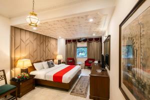 a hotel room with a bed and a desk at Hotel Kwality Regency in Chandīgarh