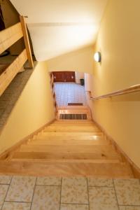 a staircase in a building with wooden flooring and a stair case at Apartments with parking space Otocac, Velebit - 20517 in Otočac
