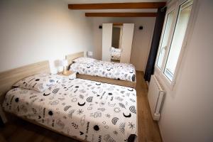 a bedroom with two beds and a window at Moulin de Tartay en Avignon in Avignon +52 photos