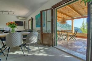 a dining room with a table and chairs and a patio at Best Views in Valldemossa in Valldemossa