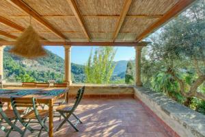 a dining room with a table and chairs on a patio at Best Views in Valldemossa in Valldemossa
