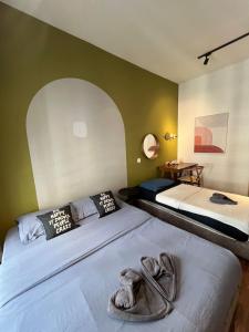 a bedroom with two beds with towels on them at K avenue Studio 2bed room A06 near airport by GC in Donggongon