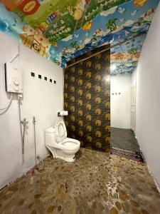 a bathroom with a toilet and a painted ceiling at Sweet Jungle Bungalows in Koh Rong Island +123 photos