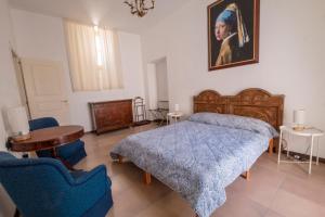 een slaapkamer met een bed en een schilderij aan de muur bij San Lorenzo by the sea in Augusta