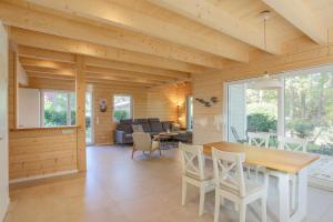 a dining room and living room with a table and chairs at Am Hafen 21 in Zislow