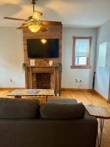 a living room with a couch and a flat screen tv at Jungle House Luxury Stays - Columbus Downtown Short North in Columbus +22 photos