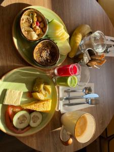 two plates of food on a wooden table at AISHAMA Healing House in Aït Ourir