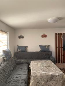 a living room with a couch and a bed at Vikendica- kuća za odmor in Goražde